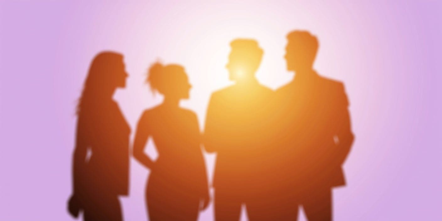 A silhouette of four business professionals